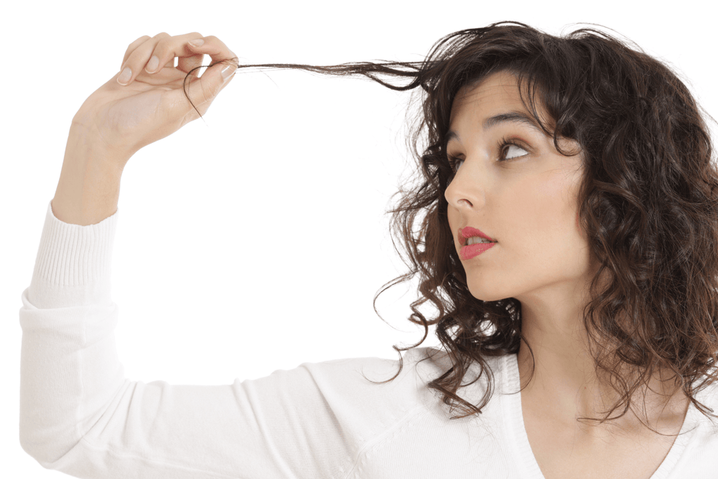 woman looking at strand of hair