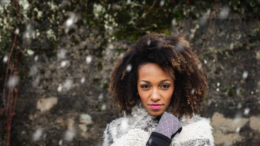 woman with curly hair in snow