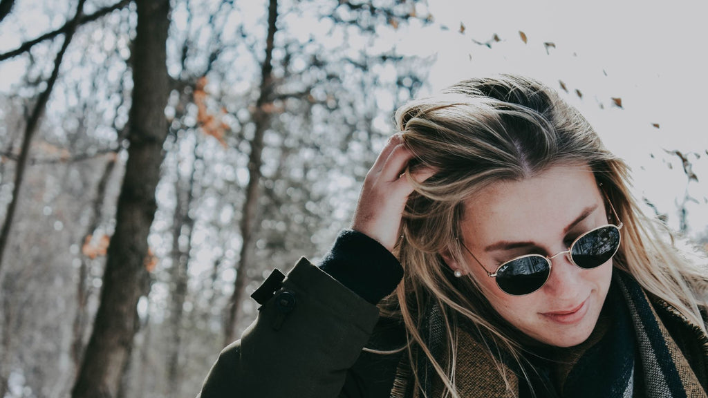 woman hair in snow sunglasses