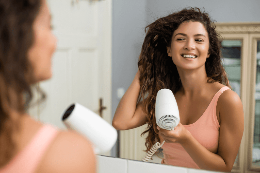 woman with blowdryer doing hair