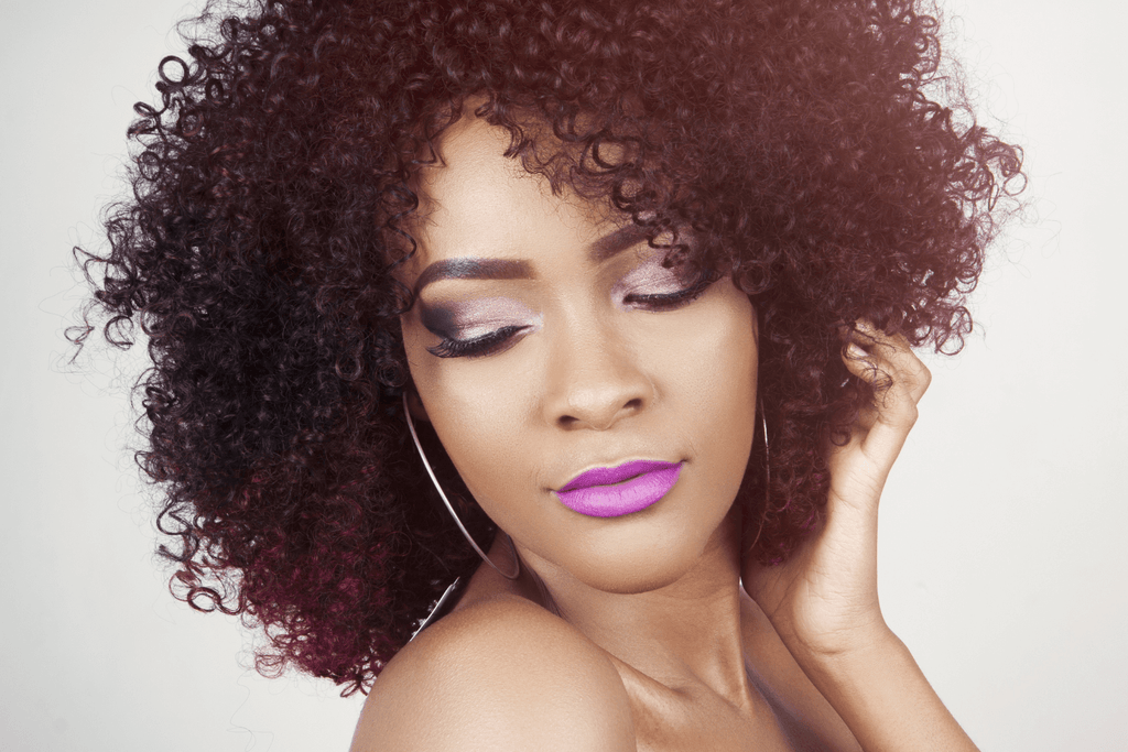 woman with curly hair purple lips