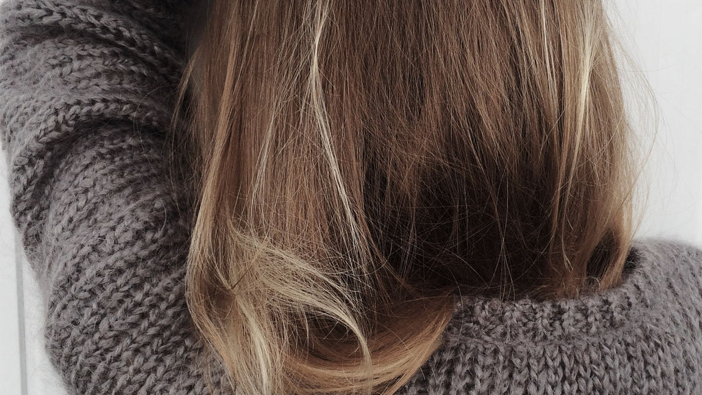 brunette hair and grey sweater