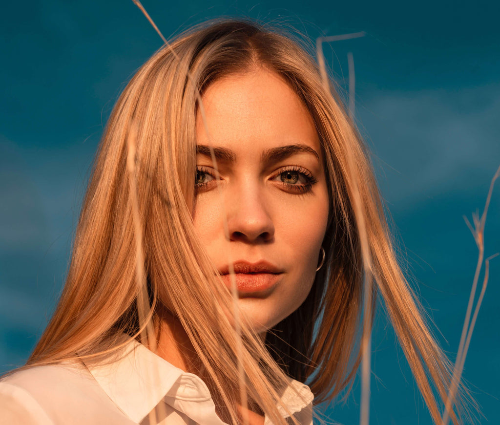 blonde woman hair blue sky