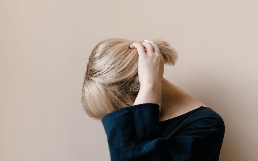 blonde woman hand in hair