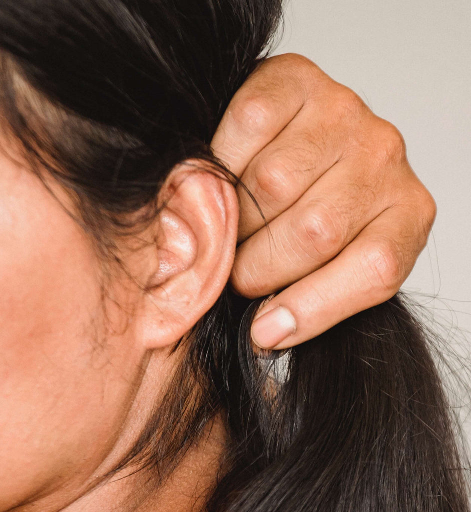 woman holding dry brunette hair