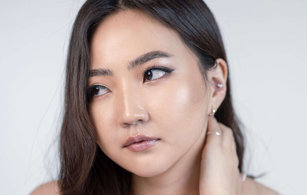 woman with brunette hair holding neck