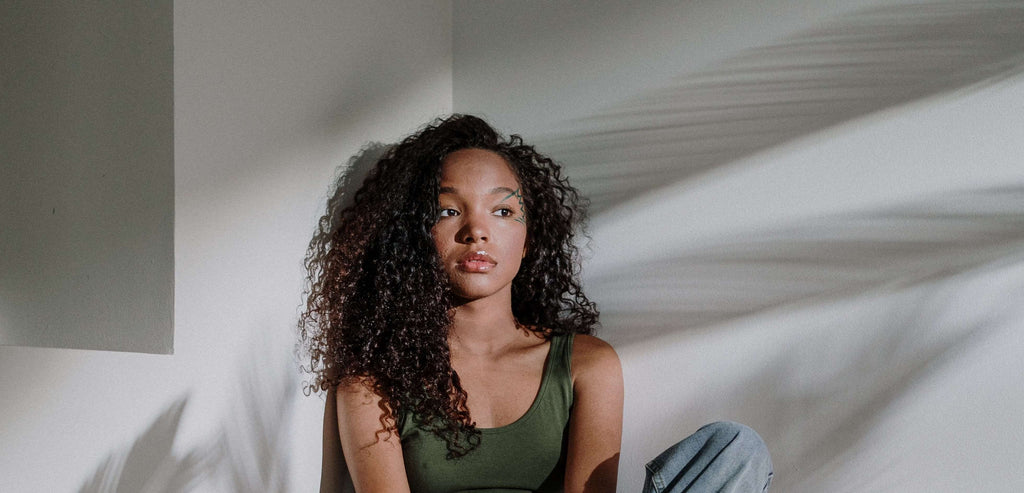 woman with curly hair in corner