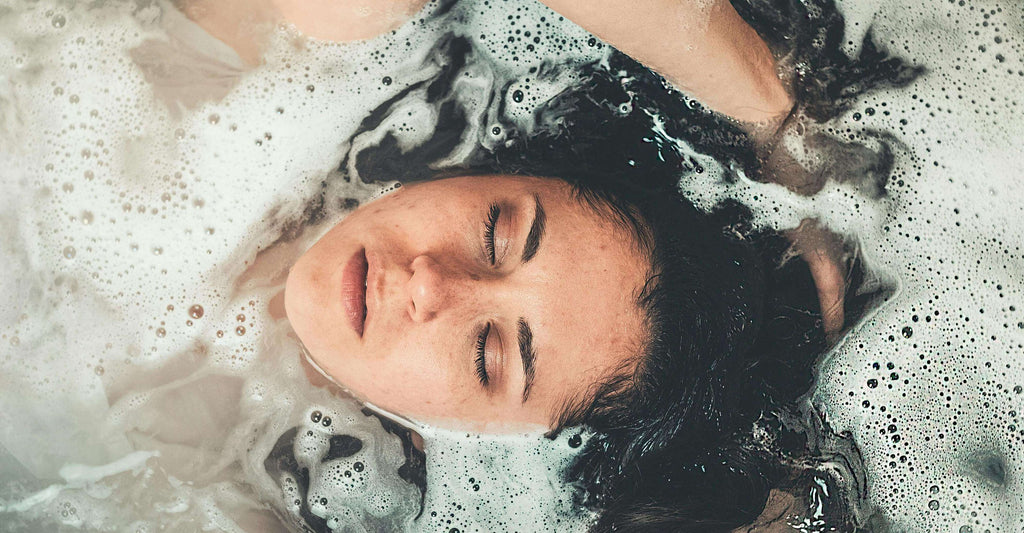 brunette woman with hair in water