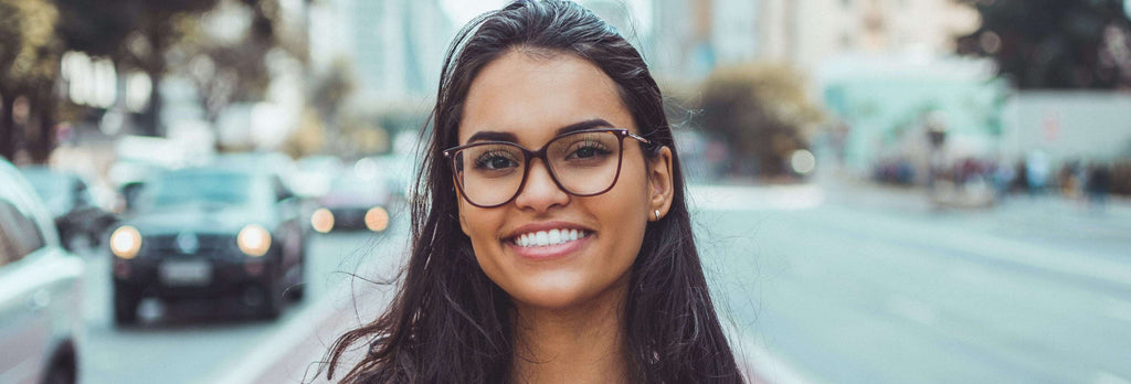 woman smiling cars in background