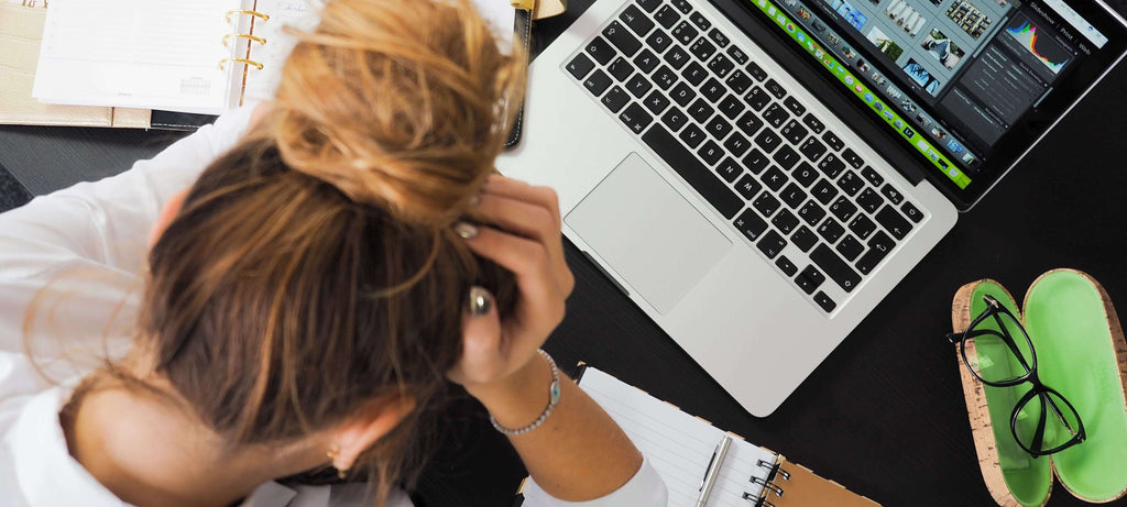 woman with hand in hair stressed