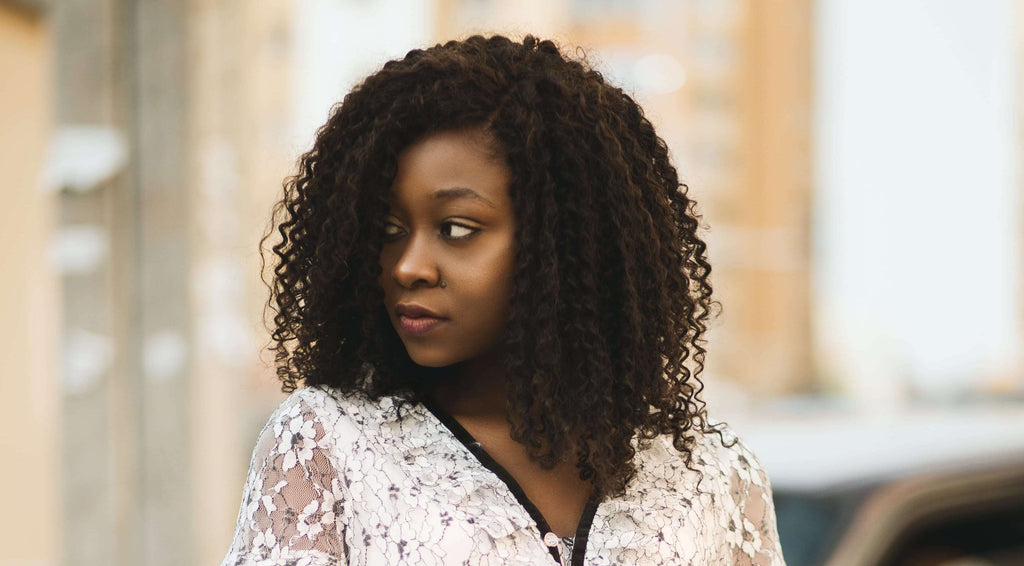 woman with curly hear wearing white