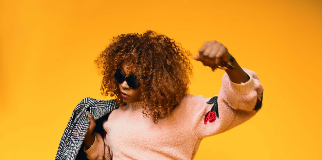 yellow background woman with kinky coily hair