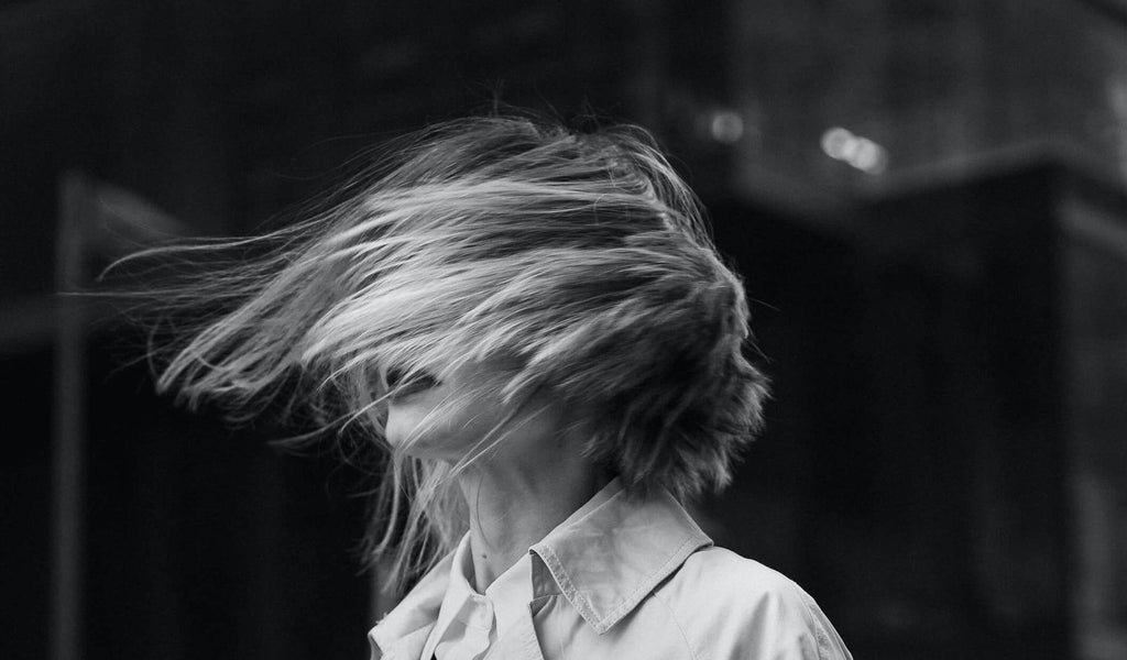 black and white image woman with hair in face