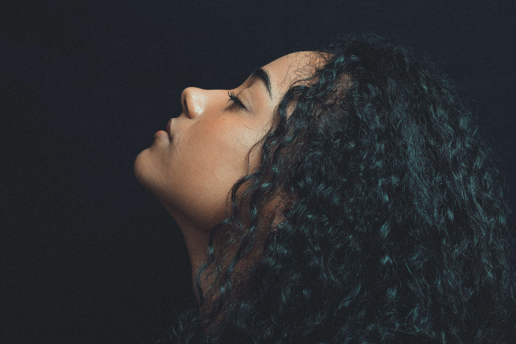 curly hair woman black background