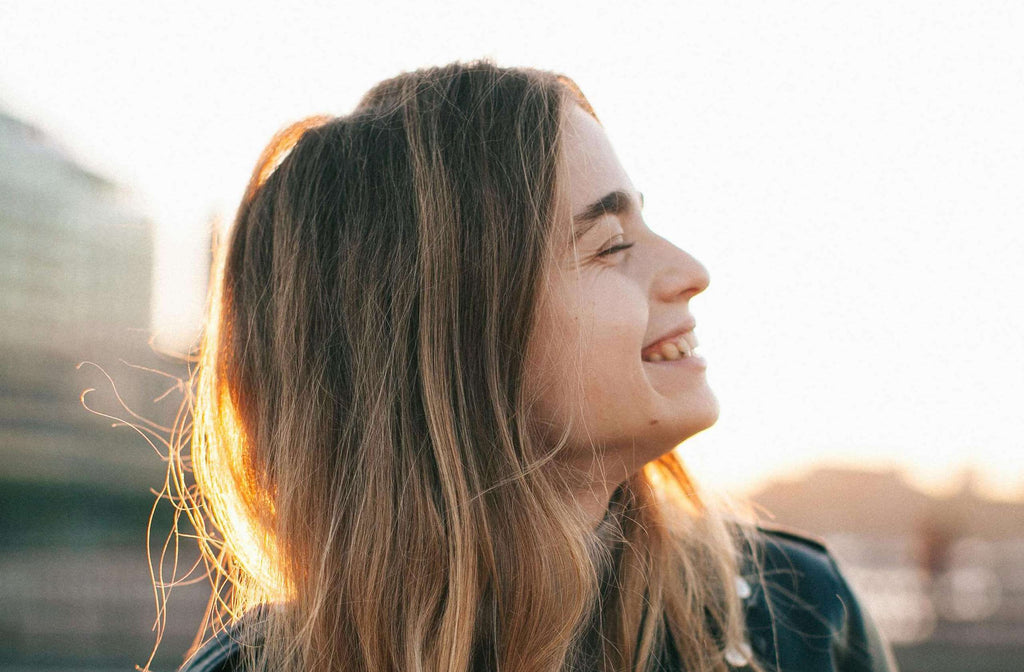 woman with blonde hair looking to the side