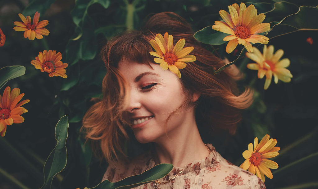 brunette woman yellow flowers in hair