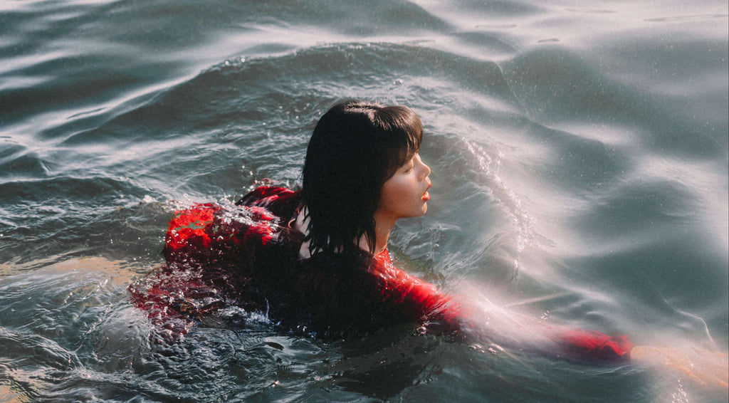 brunette woman in red swimming