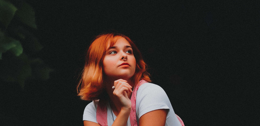 woman with orange hair black background