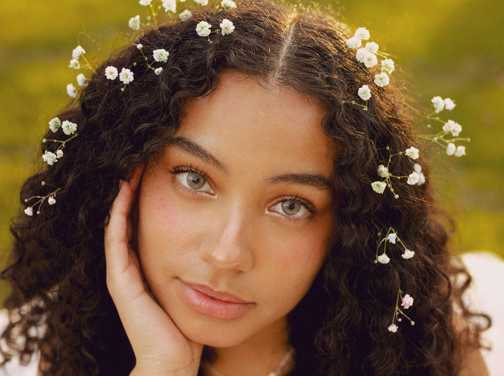 curly hair with flowers woman