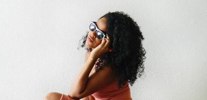 woman with curly hair glasses