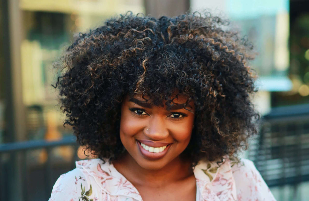 smiling woman with curly brunette hair