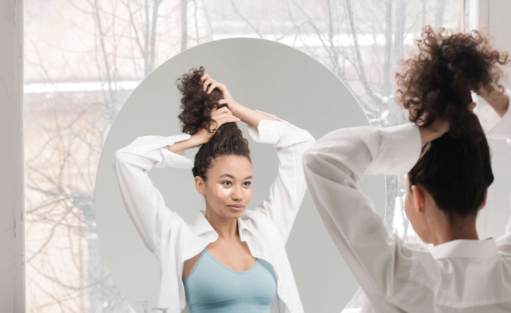 woman curly hair mirror