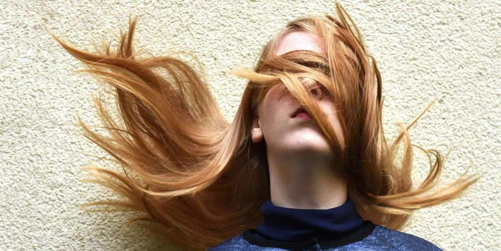 woman with strawberry blonde hair in face