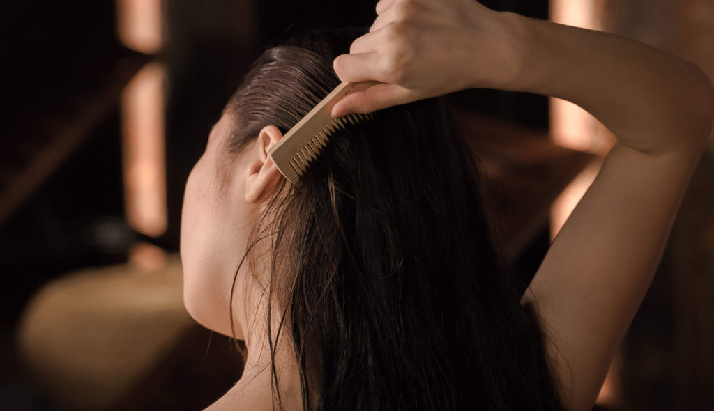 woman with brunette hair holding comb