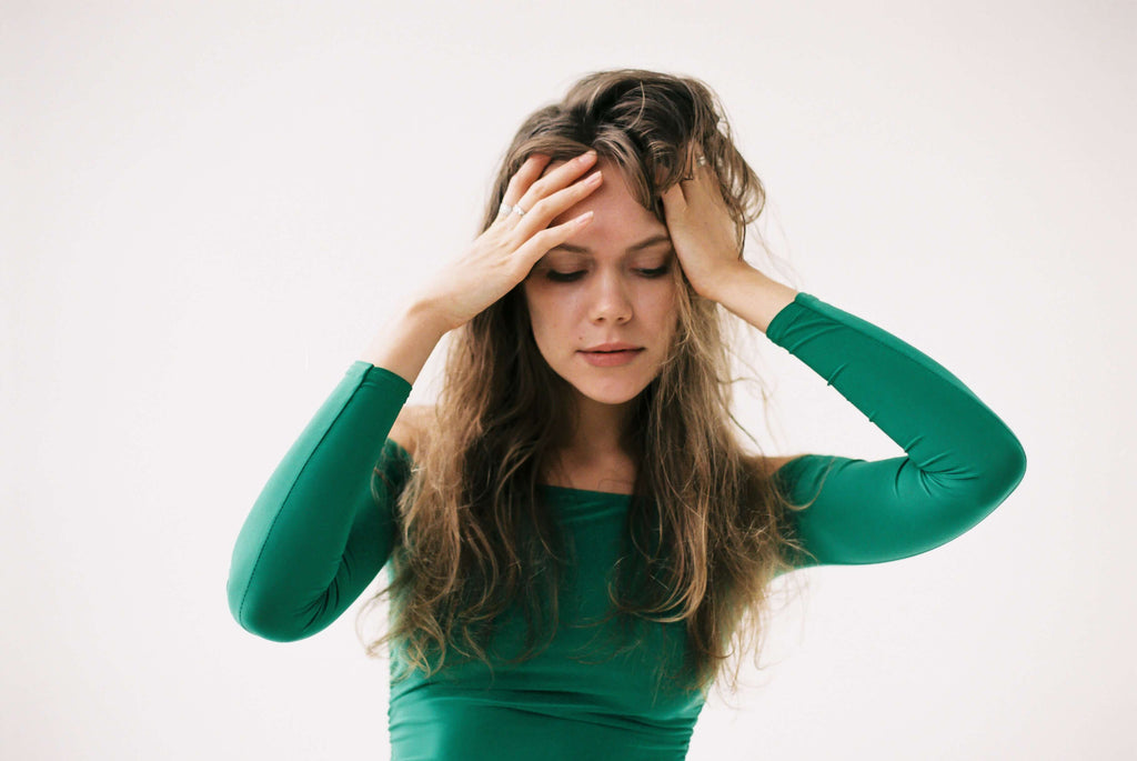 brunette woman holding hair