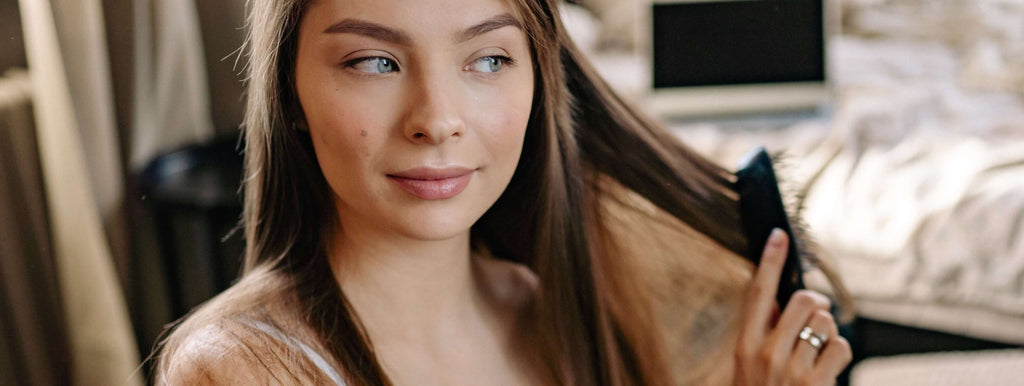 woman brushing brunette hair